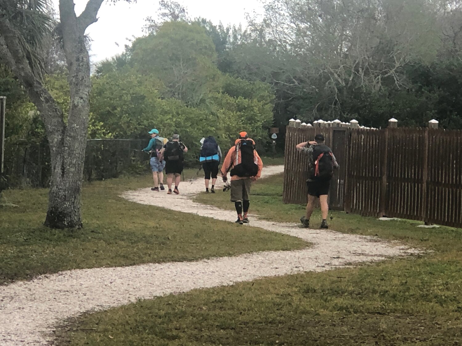Hikers disappear toward the swamps of the Big Cypress section of the Florida Trail at the Southern Terminus.
